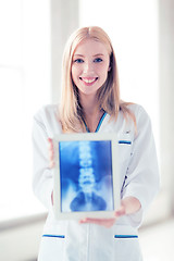 Image showing female doctor with x-ray on tablet pc