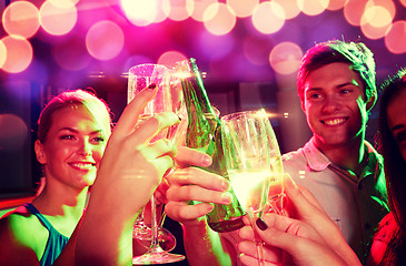 Image showing smiling friends with wine glasses and beer in club