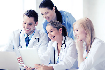 Image showing group of doctors looking at tablet pc