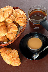 Image showing cup of coffee with fresh croissants