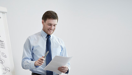 Image showing smiling businessman on presentation in office