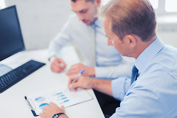 Image showing businessmen with notebook on meeting