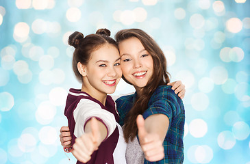 Image showing happy smiling teenage girls showing thumbs up