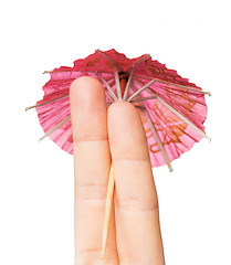 Image showing close up of two fingers with cocktail umbrella