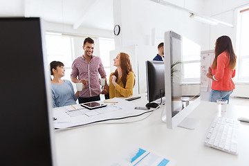 Image showing happy creative team rinking coffee at office