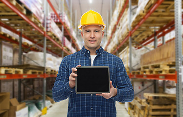 Image showing happy businessman with tablet pc at warehouse