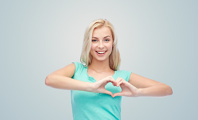 Image showing happy woman or teen girl showing heart shape sigh
