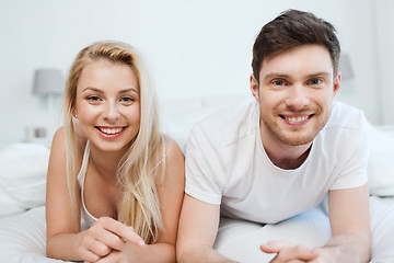 Image showing happy couple lying in bed at home