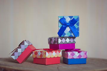 Image showing Gift box with blue bow on wood background