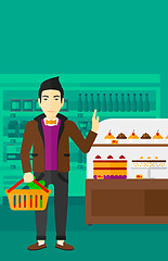 Image showing Man holding supermarket basket.