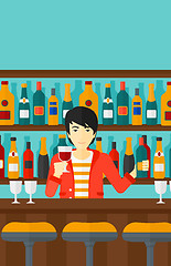 Image showing Bartender standing at the bar counter.