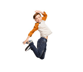 Image showing happy smiling boy jumping in air