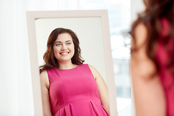 Image showing happy plus size woman posing at home mirror