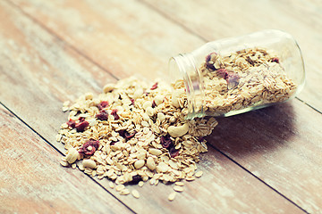 Image showing close up of jar with granola or muesli on table