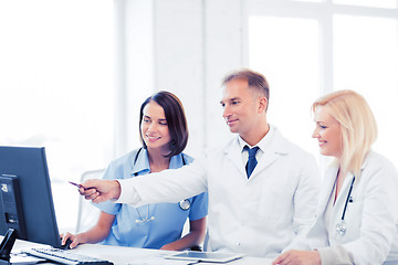 Image showing doctors looking at computer on meeting