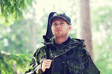 Image showing young soldier or hunter with gun in forest