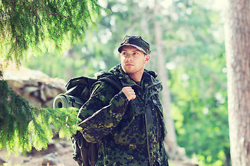 Image showing young soldier with backpack in forest