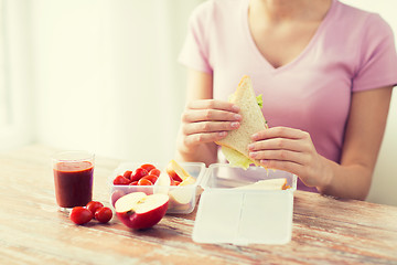 Image showing close up of woman with food in plastic container