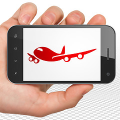 Image showing Travel concept: Hand Holding Smartphone with Airplane on display