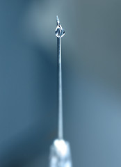 Image showing syringe close-up, focus on the drop