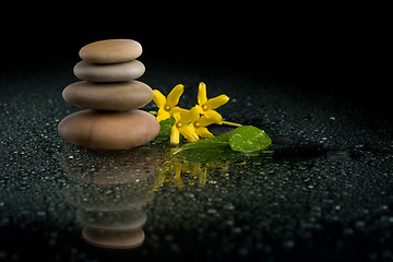 Image showing balancing zen stones on black with yellow flower