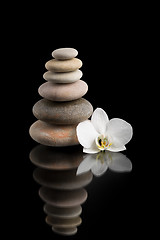 Image showing balancing zen stones on black with white flower