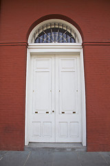 Image showing White door, red building