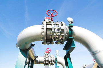 Image showing Industrial zone, Steel pipelines and valves against blue sky