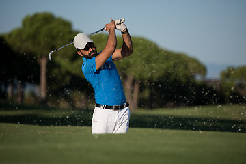 Image showing pro golfer hitting a sand bunker shot