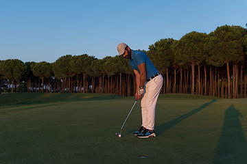 Image showing golfer  hitting shot at golf course