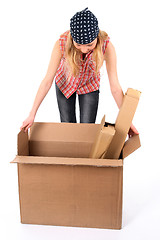 Image showing Young woman looking into an open box