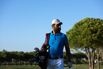 Image showing golfer  walking and carrying bag