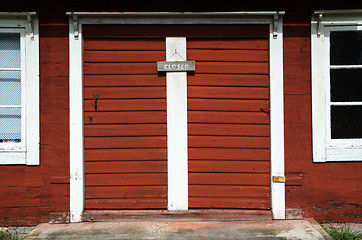 Image showing Old red doors with closed sign
