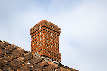 Image showing Red chimney at an old rooftop
