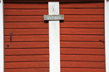 Image showing Closed sign at two red doors