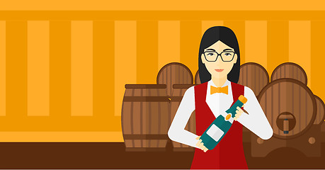 Image showing Waitress holding bottle of wine.