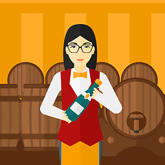 Image showing Waitress holding bottle of wine.