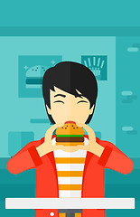 Image showing Man eating hamburger. 