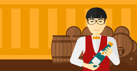 Image showing Waiter holding bottle of wine.