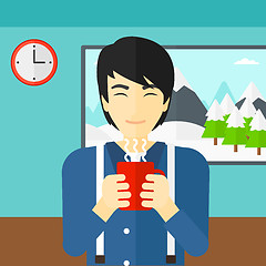 Image showing Man holding cup of coffee.