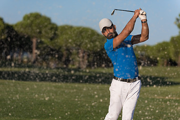 Image showing pro golfer hitting a sand bunker shot