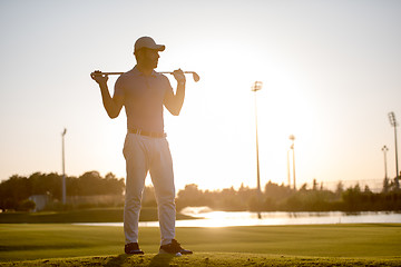 Image showing golfer  portrait at golf course on sunset