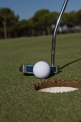 Image showing hitting golf ball to hole