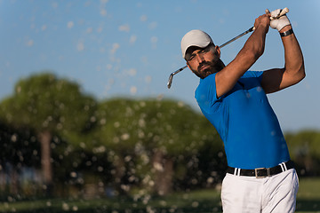 Image showing pro golfer hitting a sand bunker shot