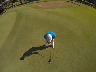 Image showing top view of golf player hitting shot