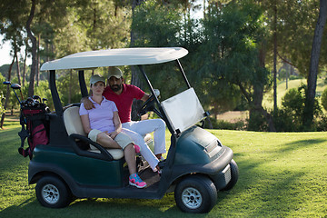 Image showing couple in buggy on golf course