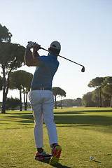 Image showing golf player hitting shot