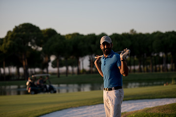 Image showing golfer  portrait at golf course on sunset