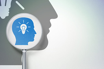 Image showing Learning concept:  Head With Light Bulb with optical glass on digital background