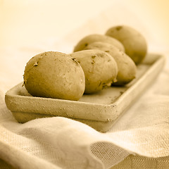 Image showing Five raw potatoes (seepia toning)